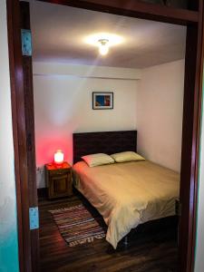 a bedroom with a bed and a lamp on a table at Killa Wasi B&B in Chachapoyas