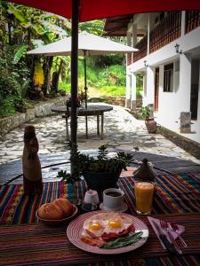 a table with a breakfast of eggs and bread on it at Killa Wasi B&B in Chachapoyas
