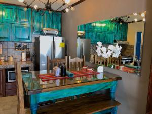 a kitchen with turquoise cabinets and a counter top at Brazilian Art & Free Parking - emitimos factura in Quetzaltenango