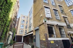 a brick building with windows on a street at BR6 - Beautiful 1 bed flat in heart of borough in London