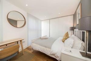 a bedroom with a bed with a mirror and a desk at Number 7 Borough Apartments 2 Bed 2 Bath in London