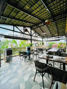 a restaurant with tables and chairs and a large window at Air Star Hotel in Ho Chi Minh City