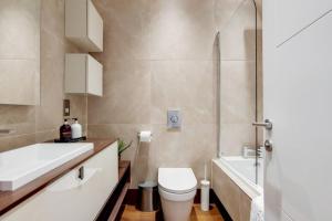 a bathroom with a toilet and a sink and a shower at Number 10 Borough Apartments 2 Bed 2 Bath in London