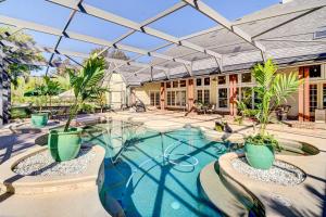 una piscina con macetas en una casa en Florida Vacation Rental with Private Pool and Dock!, en Merritt Island