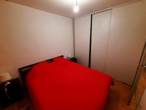 czerwone łóżko w pokoju z szafą w obiekcie Charmant T2 au cœur de Bayonne, proche commodités - FR-1-239-891 w Bajonnie