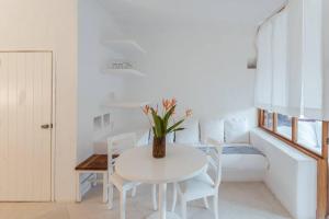 - une salle à manger blanche avec une table et des chaises blanches dans l'établissement Loft - 1 bedroom in El Careyes Club, à Careyes