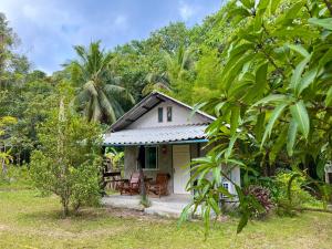a small white house in the middle of a forest at Eve house koh kood in Ko Kood