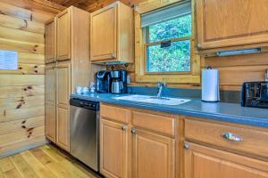 a kitchen with a sink and a dishwasher at Bryson City Cabin Rental with Mountain View, Hot Tub in Bryson City