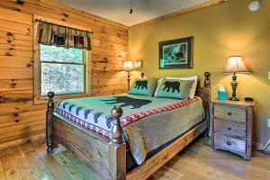 a bedroom with a bed and a window at Bryson City Cabin Rental with Mountain View, Hot Tub in Bryson City