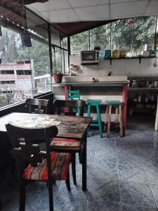 a restaurant with tables and chairs and a kitchen at ECO ART Best view Machu Picchu in Machu Picchu