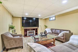 a living room with couches and a flat screen tv at Family Vacation Rental 18 Mi to Philadelphia in Gibbstown