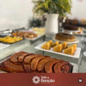 a buffet of food with sausages and other foods at Valle da Benção Pousada in Chapada dos Guimarães