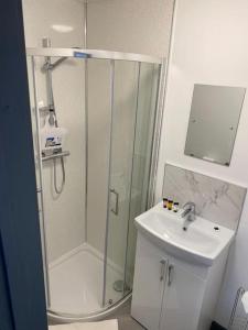 a bathroom with a shower and a sink at Newly refurbished studio, great location 8 studios in Nottingham