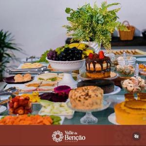 a table topped with lots of different types of food at Valle da Benção Pousada in Chapada dos Guimarães