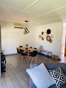 a living room with a table and chairs at Family fun in Vaal Marina in Vaal Marina