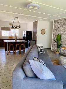 a living room with a couch and a dining room at Family fun in Vaal Marina in Vaal Marina