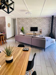 a living room with a large couch and a brick wall at Family fun in Vaal Marina in Vaal Marina