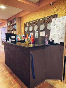 a reception counter in a room with clocks on the wall at Flamingo in Dushanbe