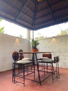 a table and two chairs and a table with a plant at Lannister Inn in Cochin