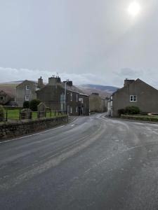 an empty street in a small town with houses at lake District cottage in Bootle