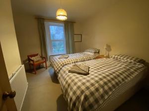 a bedroom with two beds and a window at lake District cottage in Bootle