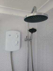 a shower head and a light in a bathroom at #31 Sundowner in Great Yarmouth