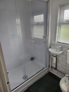 a bathroom with a shower and a sink at The Bobbers in Great Yarmouth