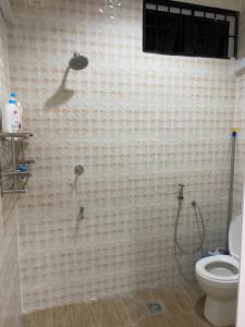 a bathroom with a shower and a toilet at AlFarizqi Muslim Residence SP in Sungai Petani