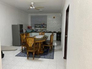 a kitchen and dining room with a table and chairs at AlFarizqi Muslim Residence SP in Sungai Petani +3 photos