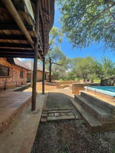 a house with a swimming pool next to a building at Intundla's Rest in Marloth Park