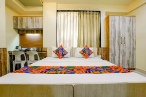 um quarto com uma cama grande e uma cozinha em FabHotel Happy Homely Stay em Pune