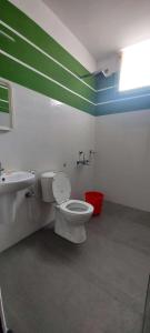 a bathroom with a toilet and a sink at Happy Seas Beach Villa in Alleppey