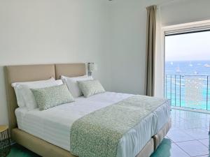 a bedroom with a bed with a view of the ocean at Casa Adelaide in Capri