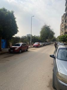 a row of cars parked on the side of a street at Salam Appartment in Cairo