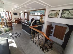 a man sitting at a bar in a restaurant at Hotel Horizon Picture Palace, Mussoorie in Mussoorie