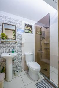 a bathroom with a toilet and a sink and a shower at Modern studio, by the ocean, 50Mbps WiFi in Panglao