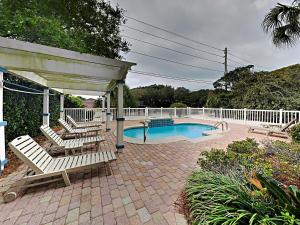 un patio con sillas y una piscina en Camellia House, en Seagrove Beach