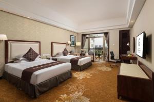a hotel room with two beds and a balcony at Maoming Country Garden Phoenix Hotel in Dianbai