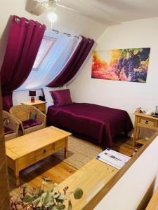 a living room with a bed and a table at Hotel Marcincak*** in Mikulov