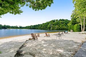 a group of chairs sitting on a beach next to a lake at Our Happy Place in Newland in Newland