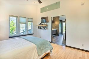a bedroom with a large bed and a bathroom at Bellingham Vacation Rental with Private Deck in Bellingham