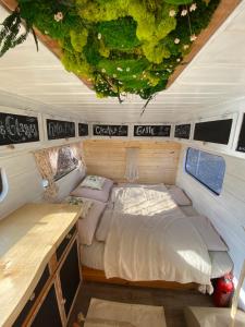 a bed in the back of a camper van at Caravan on Ranch in Třebívlice