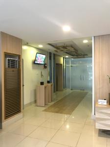 an empty lobby with a television on a wall at South Residences staycation in Manila