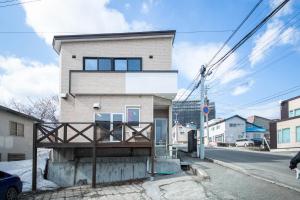 a house on the side of a street at Sumiyoshi House Room B in Otaru
