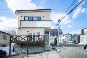a house on the side of a street at Sumiyoshi House Room A in Otaru