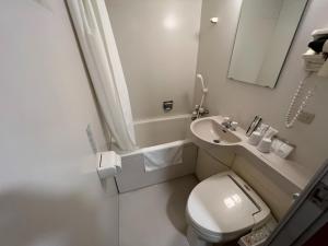 a small bathroom with a toilet and a sink at Kitami Daiichi Hotel - Vacation STAY 45969v in Kitami