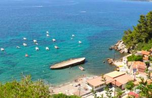 a beach with a large boat in the water at Appart'Hotel au Pradet in Le Pradet