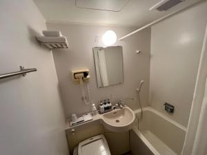 a small bathroom with a toilet and a sink at Kitami Daiichi Hotel - Vacation STAY 73137v in Kitami