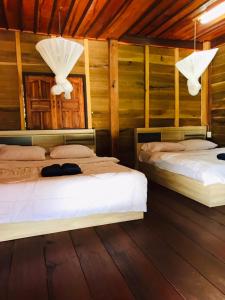 Ένα ή περισσότερα κρεβάτια σε δωμάτιο στο Motho Homestay โมโทโฮมสเตย์