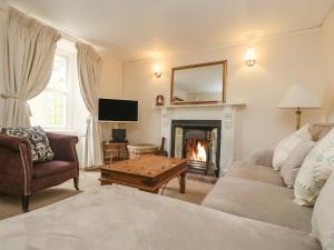 a living room with a couch and a fireplace at Little Chycoose in Truro